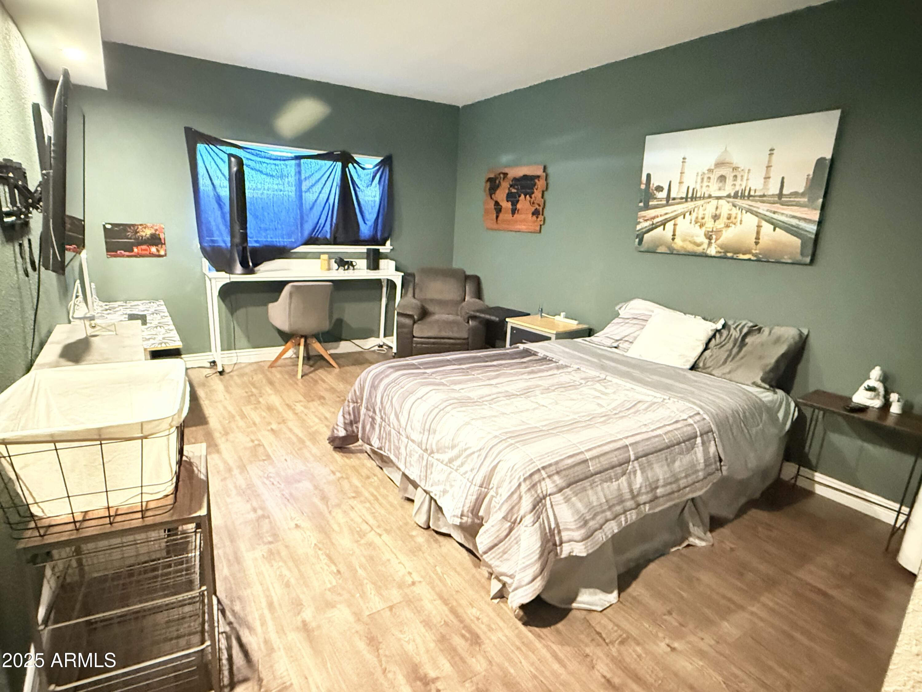 357 East Thomas Road, Unit A105 Phoenix, AZ 85012 - Photo 24 of 51 a bedroom with a bed and cupboard