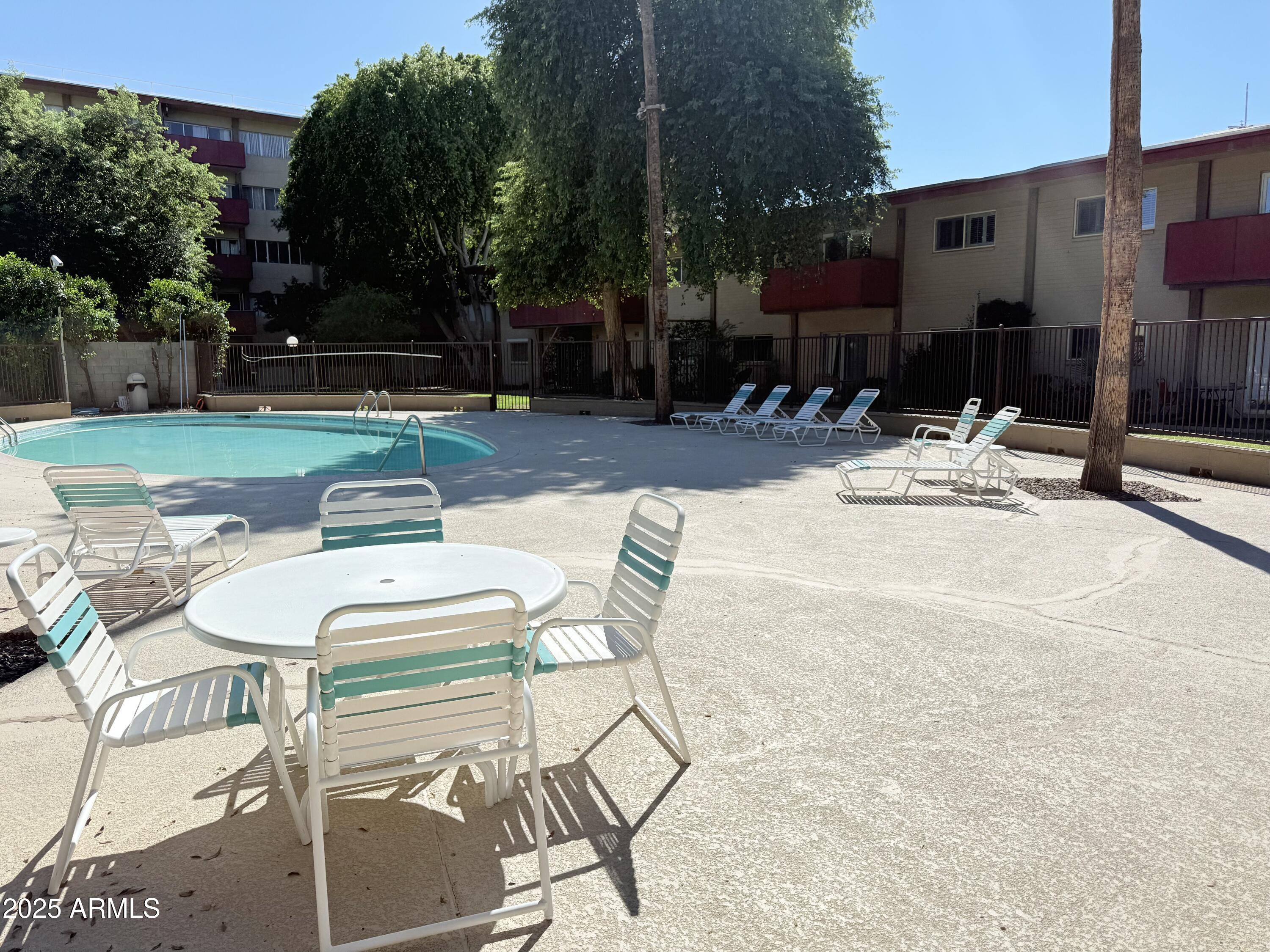 357 East Thomas Road, Unit A105 Phoenix, AZ 85012 - Photo 47 of 51 a view of a patio with a table and chairs