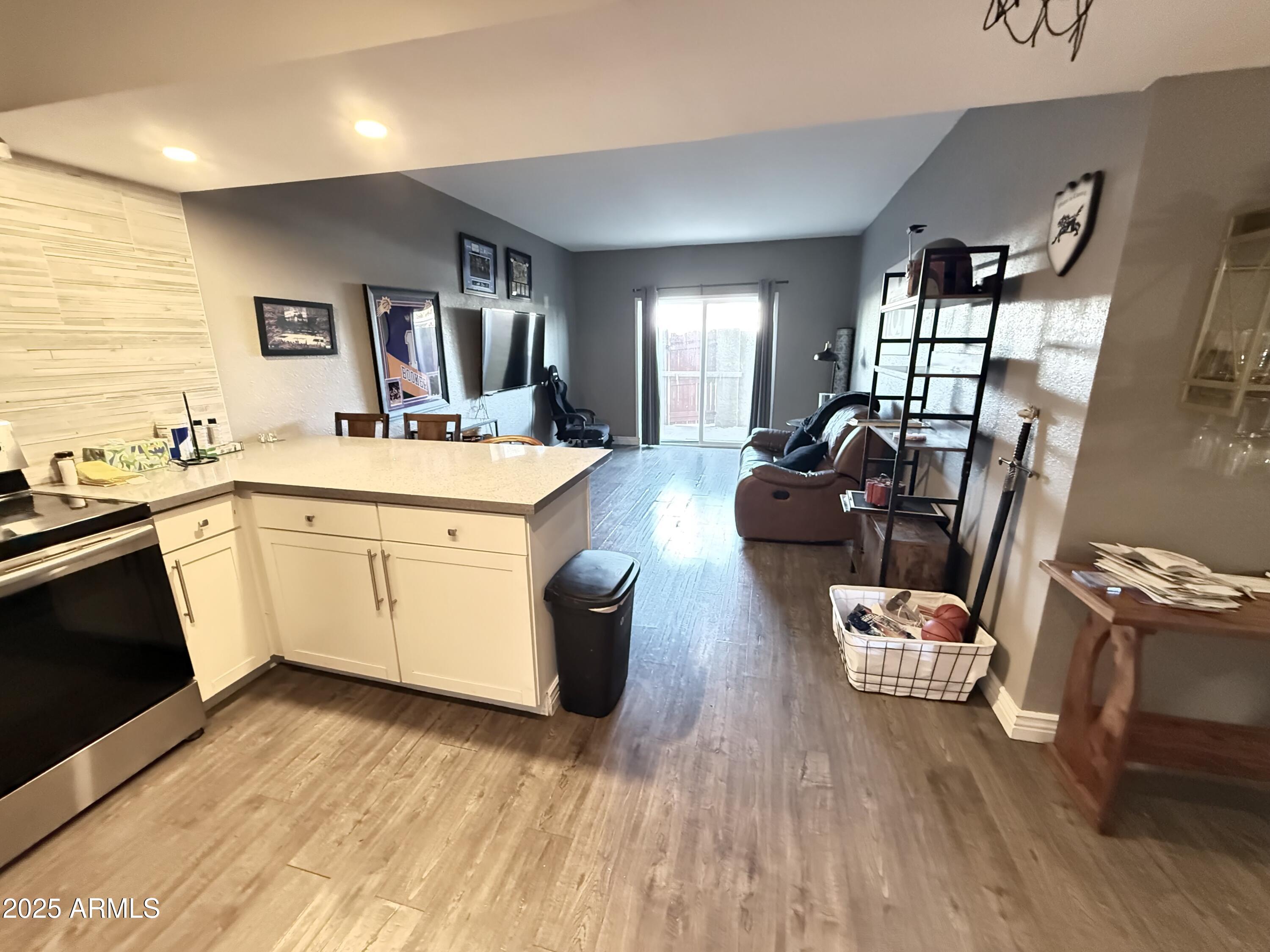 357 East Thomas Road, Unit A105 Phoenix, AZ 85012 - Photo 6 of 51 a large white kitchen with wooden floor