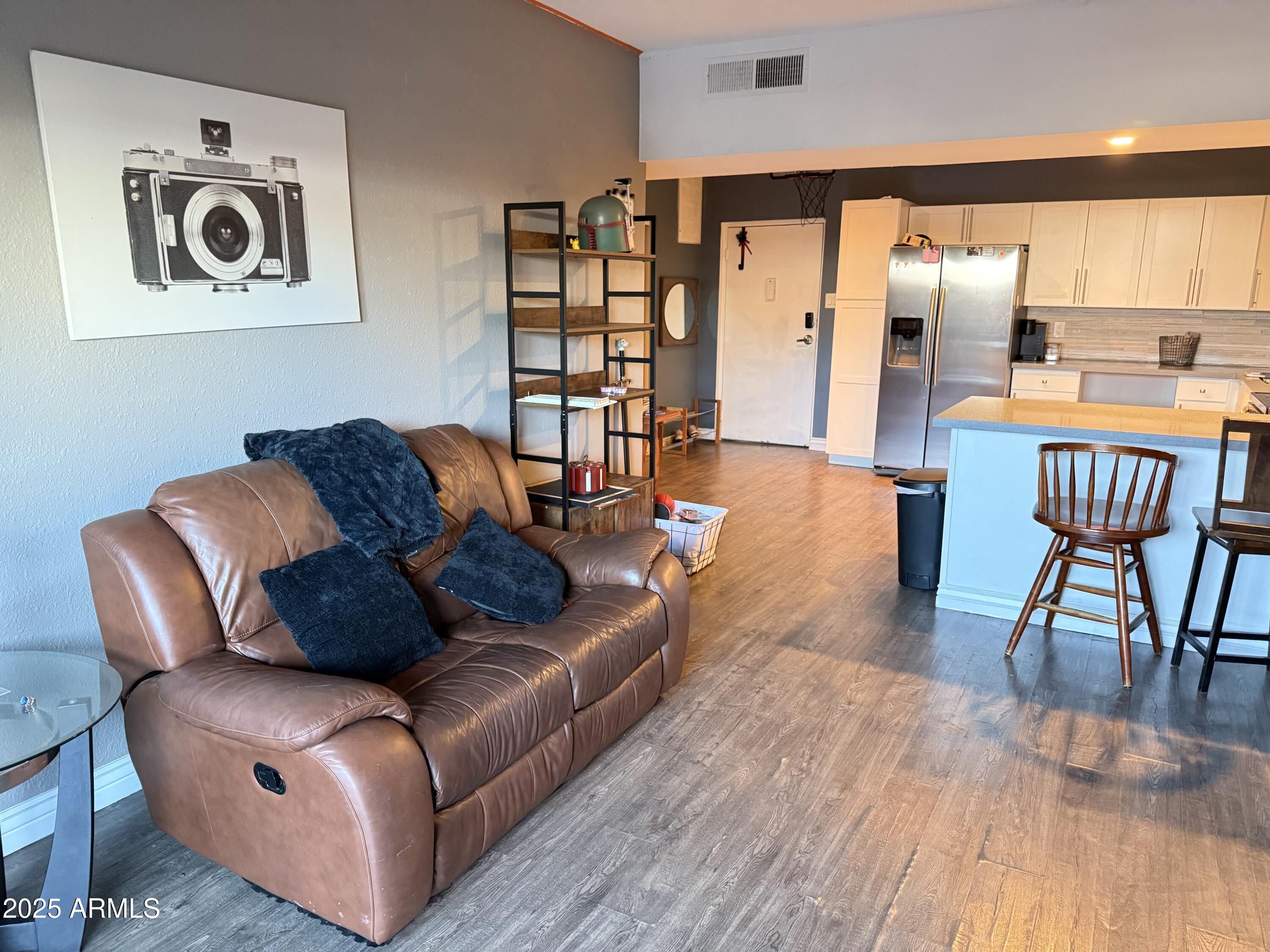 357 East Thomas Road, Unit A105 Phoenix, AZ 85012 - Photo 8 of 51 a living room with furniture and a wooden floor