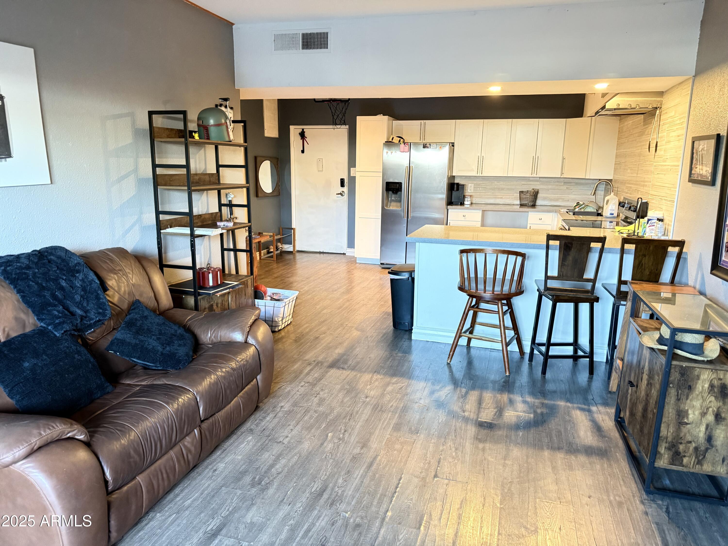 357 East Thomas Road, Unit A105 Phoenix, AZ 85012 - Photo 9 of 51 a living room with furniture and a wooden floor