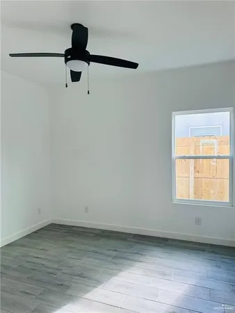 a view of a room with wooden floor cabinet and a window