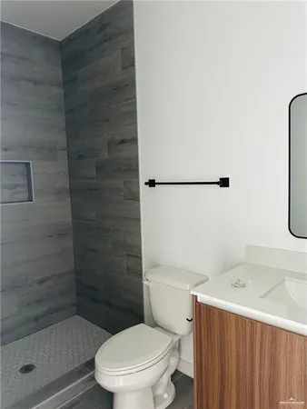 a bathroom with a toilet and a shower