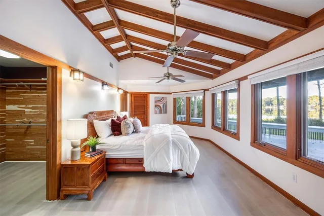 a bedroom with a bed and a painting on the wall