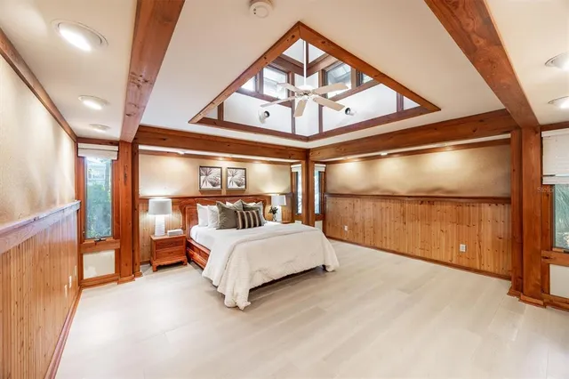 a large bedroom with a large bed and a large window