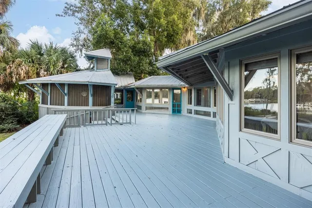 a front view of a house with a garden and deck