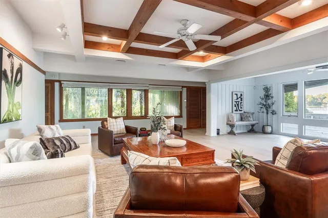 a living room with furniture a ceiling fan and a rug