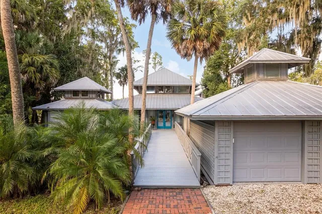 an aerial view of a house with swimming pool patio and lake view
