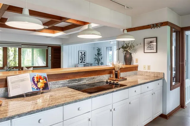 a bathroom with a granite countertop sink a large mirror and a window