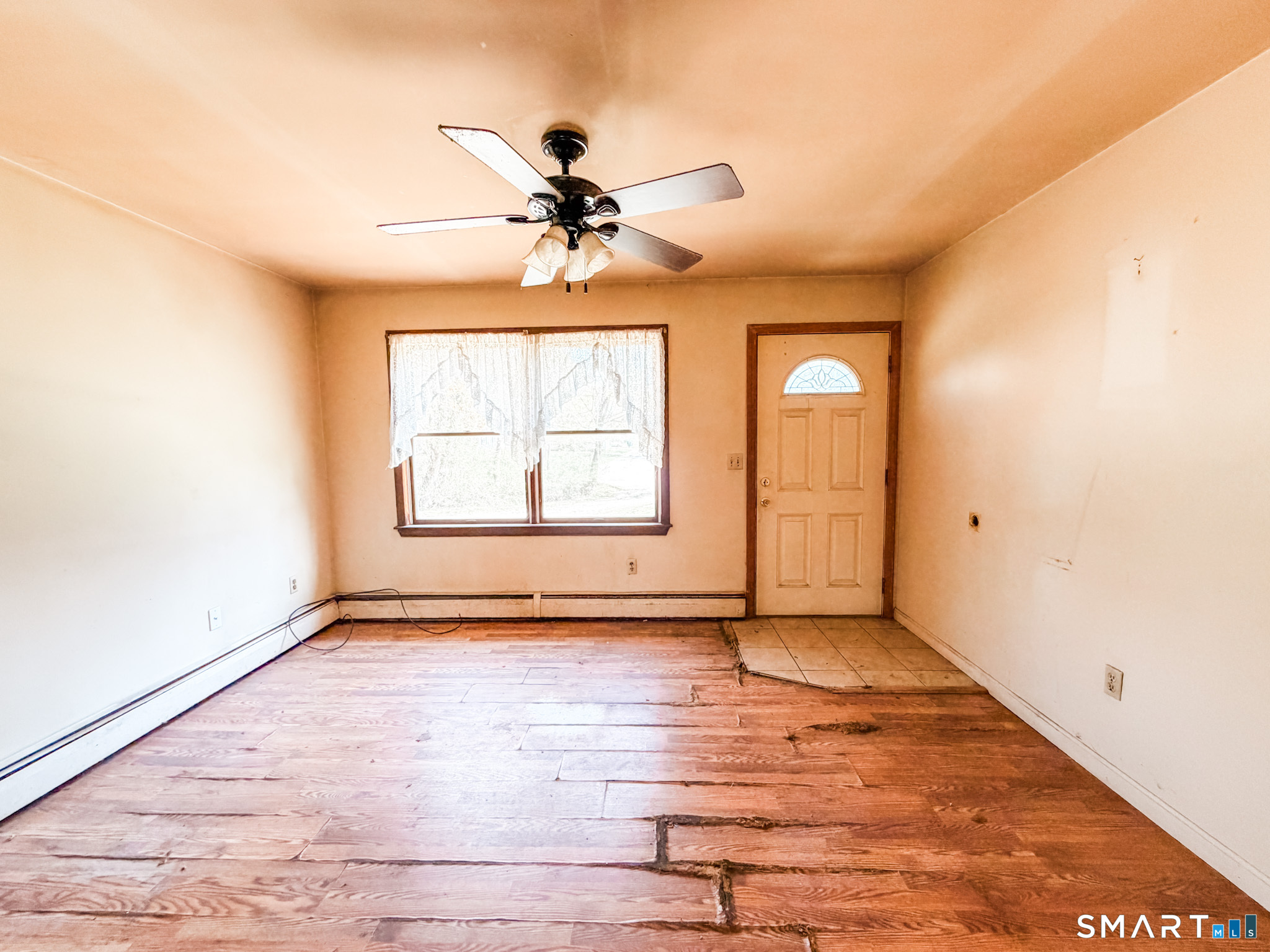 21 Potvin Avenue Plainfield, CT 06354 - Photo 4 of 17 an empty room with wooden floor chandelier fan and windows