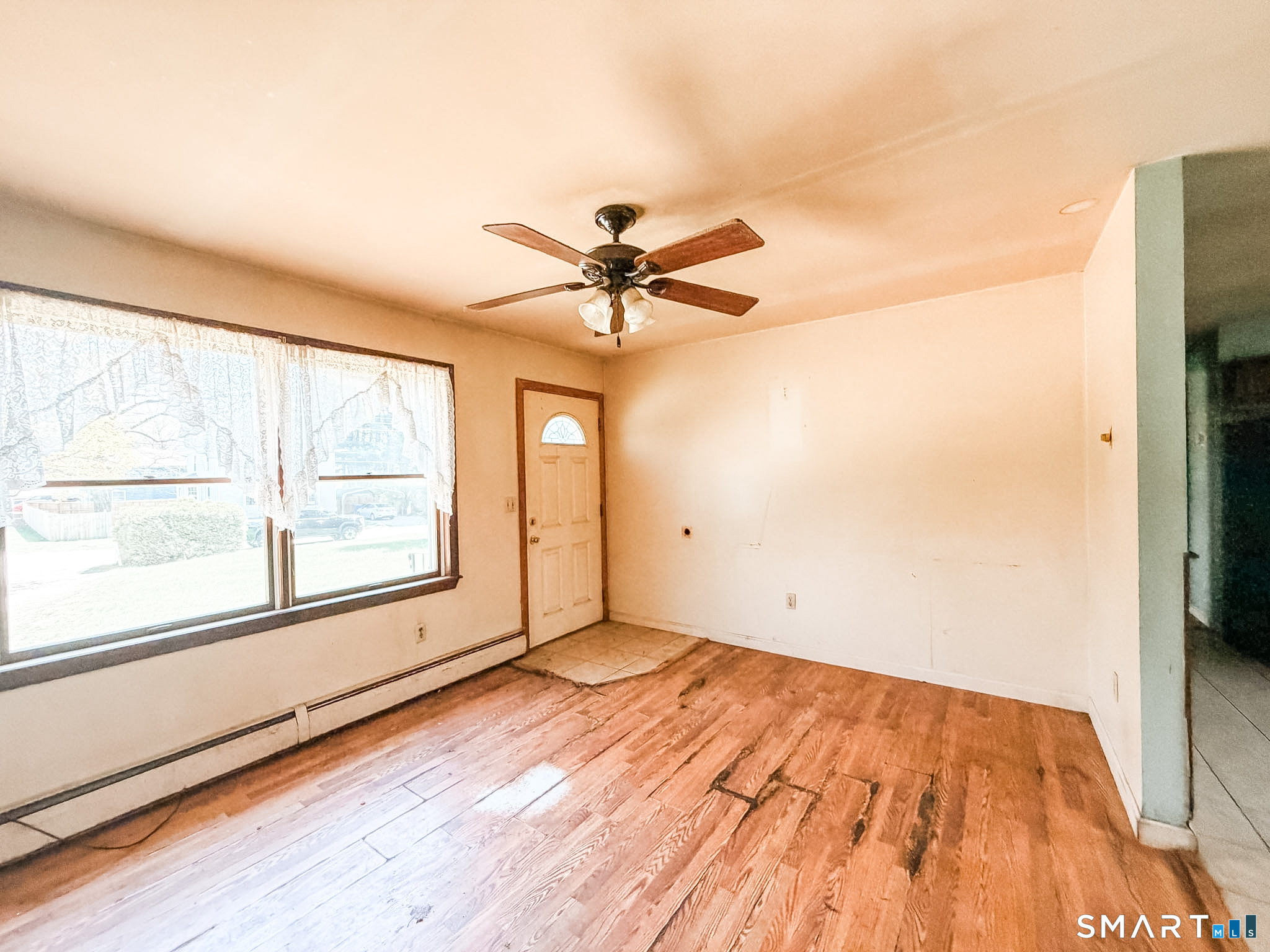 21 Potvin Avenue Plainfield, CT 06354 - Photo 5 of 17 an empty room with wooden floor and windows