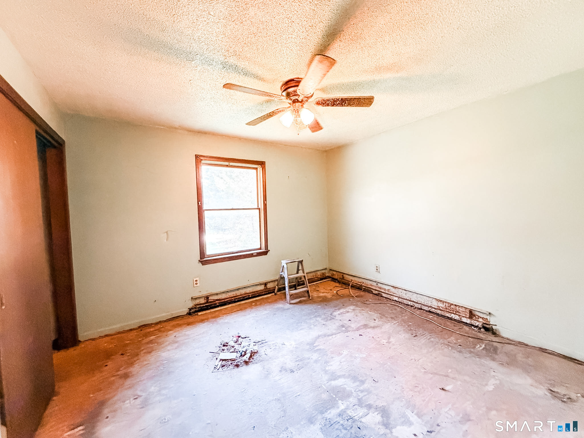 21 Potvin Avenue Plainfield, CT 06354 - Photo 10 of 17 an empty room with windows and fan