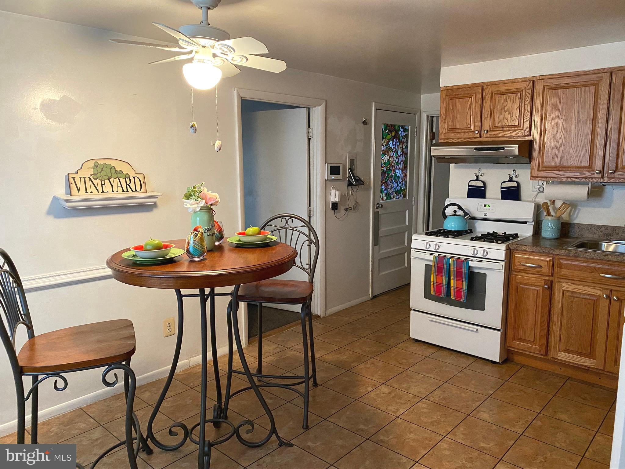 601 Banyan Road Edgewood, MD 21040 - Photo 9 of 31 a kitchen with stainless steel appliances kitchen island granite countertop a table chairs and a refrigerator