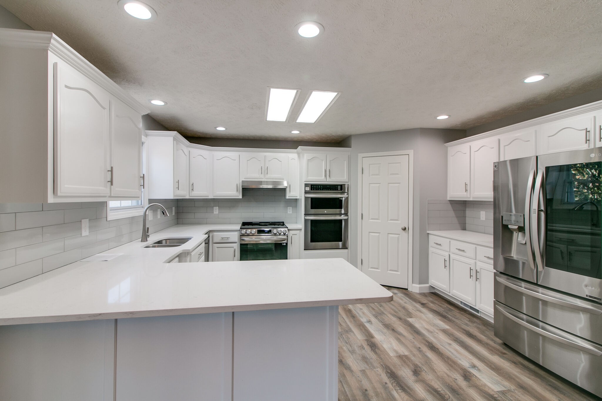 3595 Rabbit Run Trail Clarksville, TN 37043 - Photo 7 of 30 a kitchen with white cabinets and stainless steel appliances