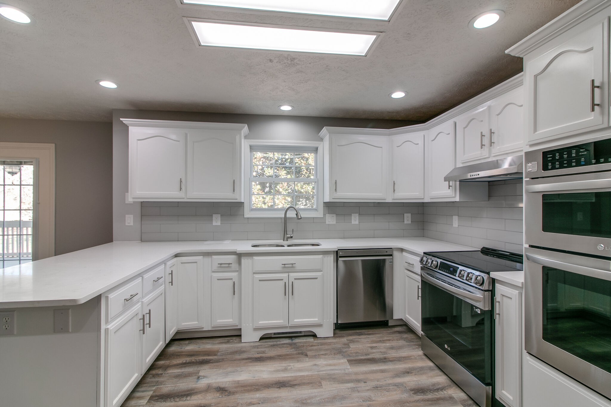 3595 Rabbit Run Trail Clarksville, TN 37043 - Photo 8 of 30 a kitchen with a sink stove cabinets and wooden floor