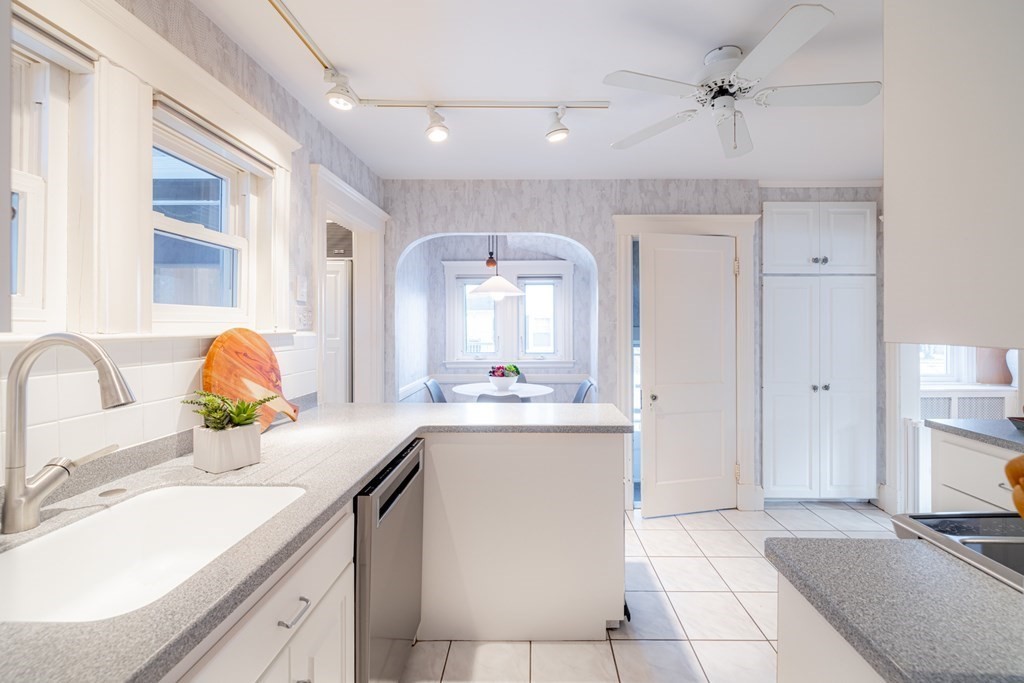 61 Nason Road Swampscott, MA 01907 - Photo 11 of 37 a kitchen with stainless steel appliances a sink and cabinets