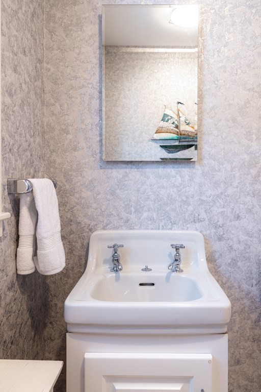 61 Nason Road Swampscott, MA 01907 - Photo 16 of 37 a bathroom with a sink and a mirror