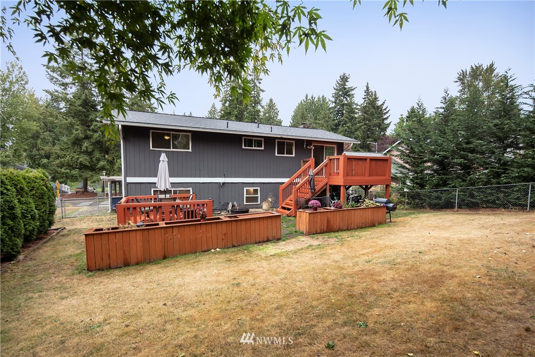 17721 Brook Boulevard Bothell, WA 98012 - Photo 22 of 26 an outdoor view of house with backyard outdoor seating and covered with trees