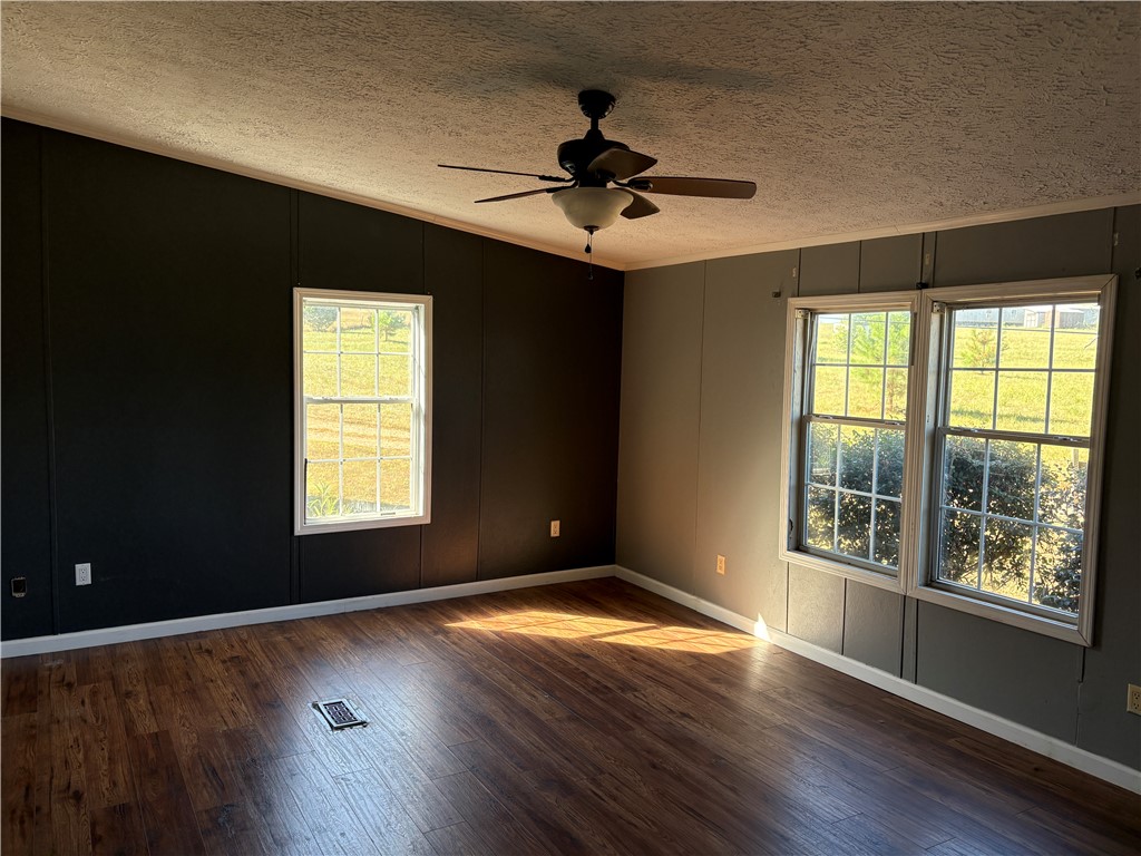 1108 Trotter Road Anderson, SC 29626 - Photo 3 of 27 Rich wood-look flooring and multiple windows enhance this versatile living area.