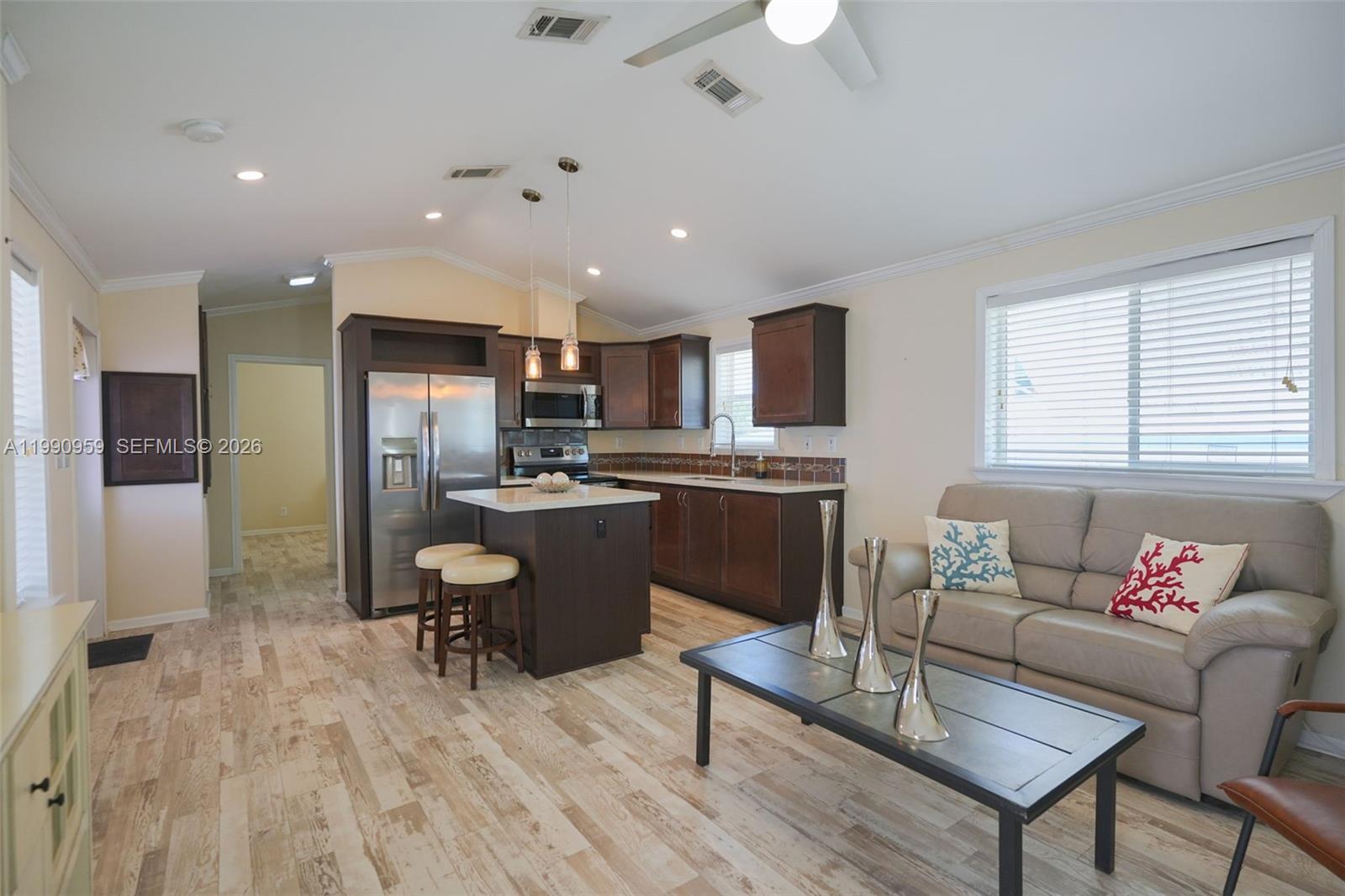 112 Tweedy Pie Terrace Key Largo, FL 33037 - Photo 16 of 39 a living room with stainless steel appliances kitchen island granite countertop furniture a rug kitchen view and a refrigerator