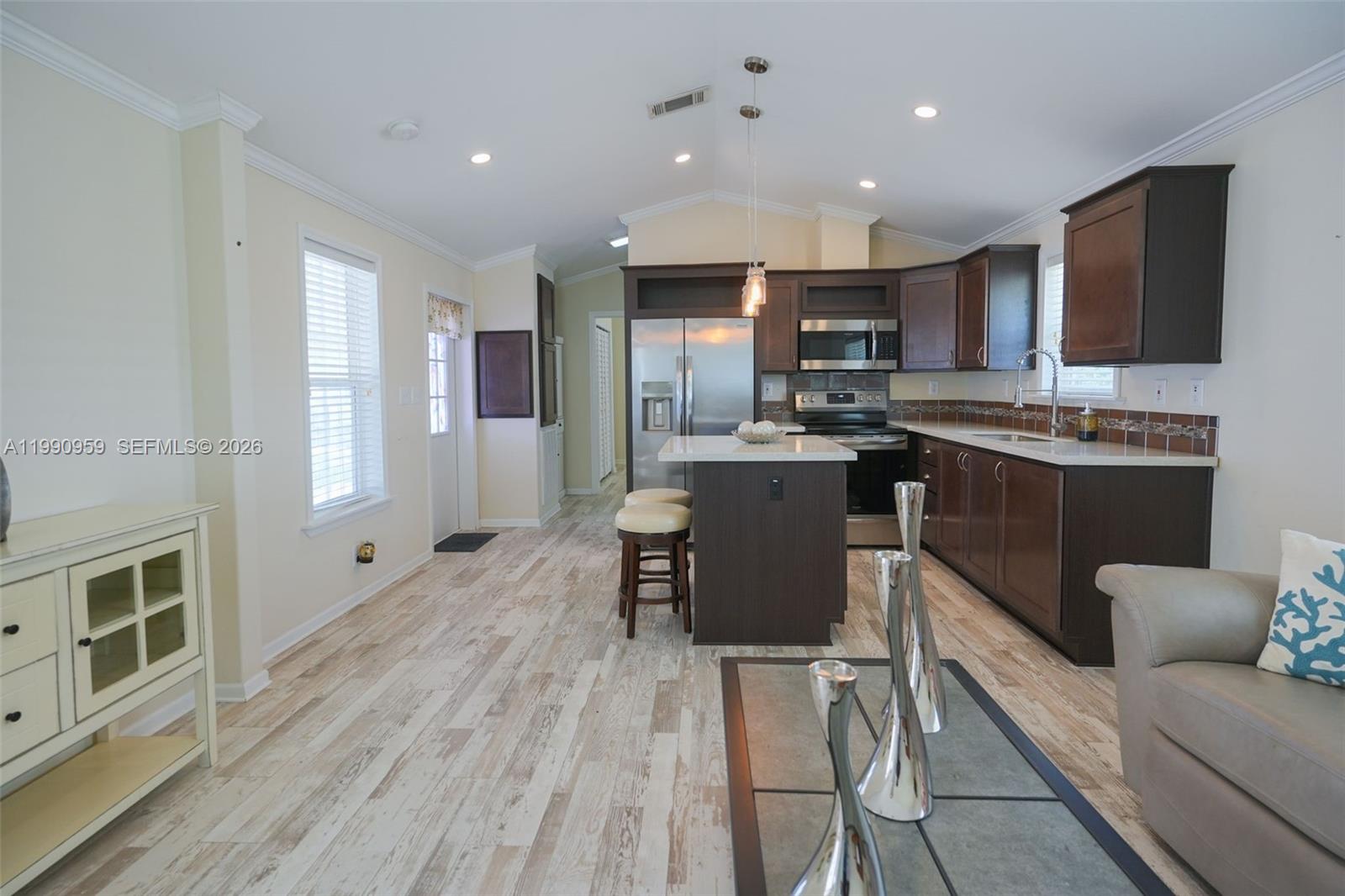 112 Tweedy Pie Terrace Key Largo, FL 33037 - Photo 17 of 39 a kitchen with stainless steel appliances kitchen island granite countertop a sink and cabinets