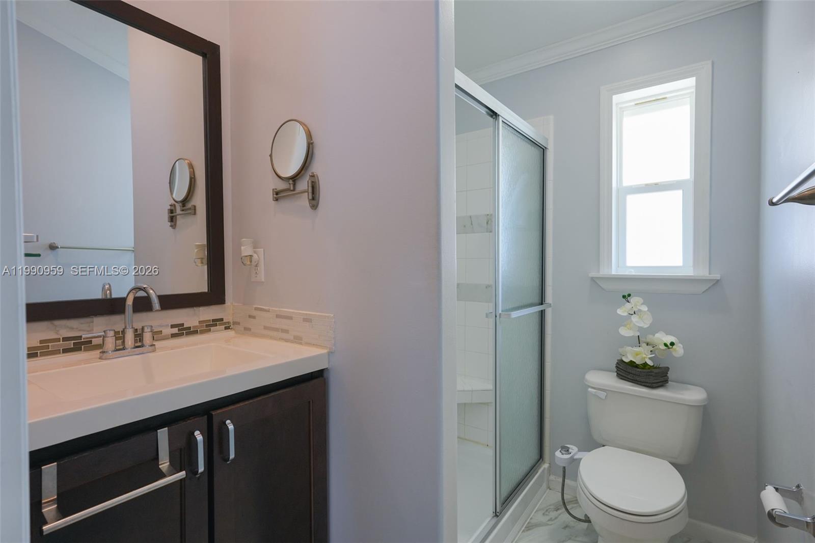 112 Tweedy Pie Terrace Key Largo, FL 33037 - Photo 23 of 39 a bathroom with a granite countertop toilet sink and mirror