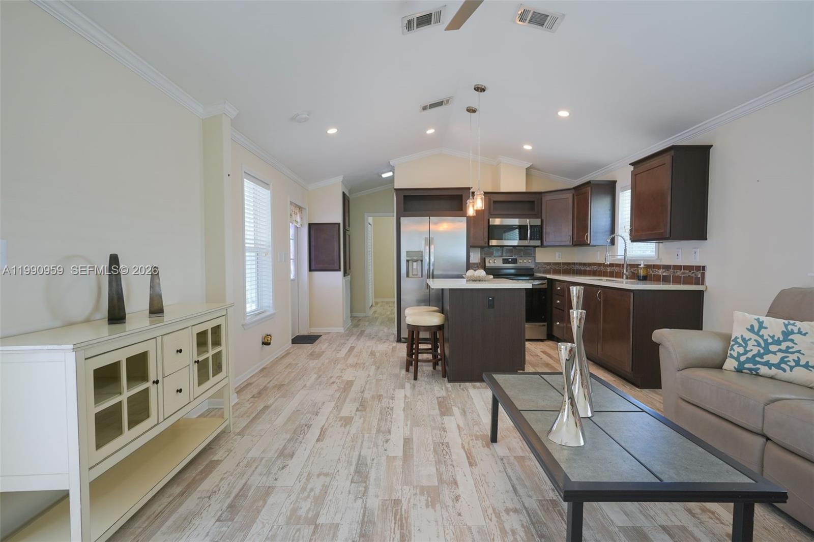 112 Tweedy Pie Terrace Key Largo, FL 33037 - Photo 29 of 39 a large kitchen with stainless steel appliances microwave stove refrigerator dining table and chairs