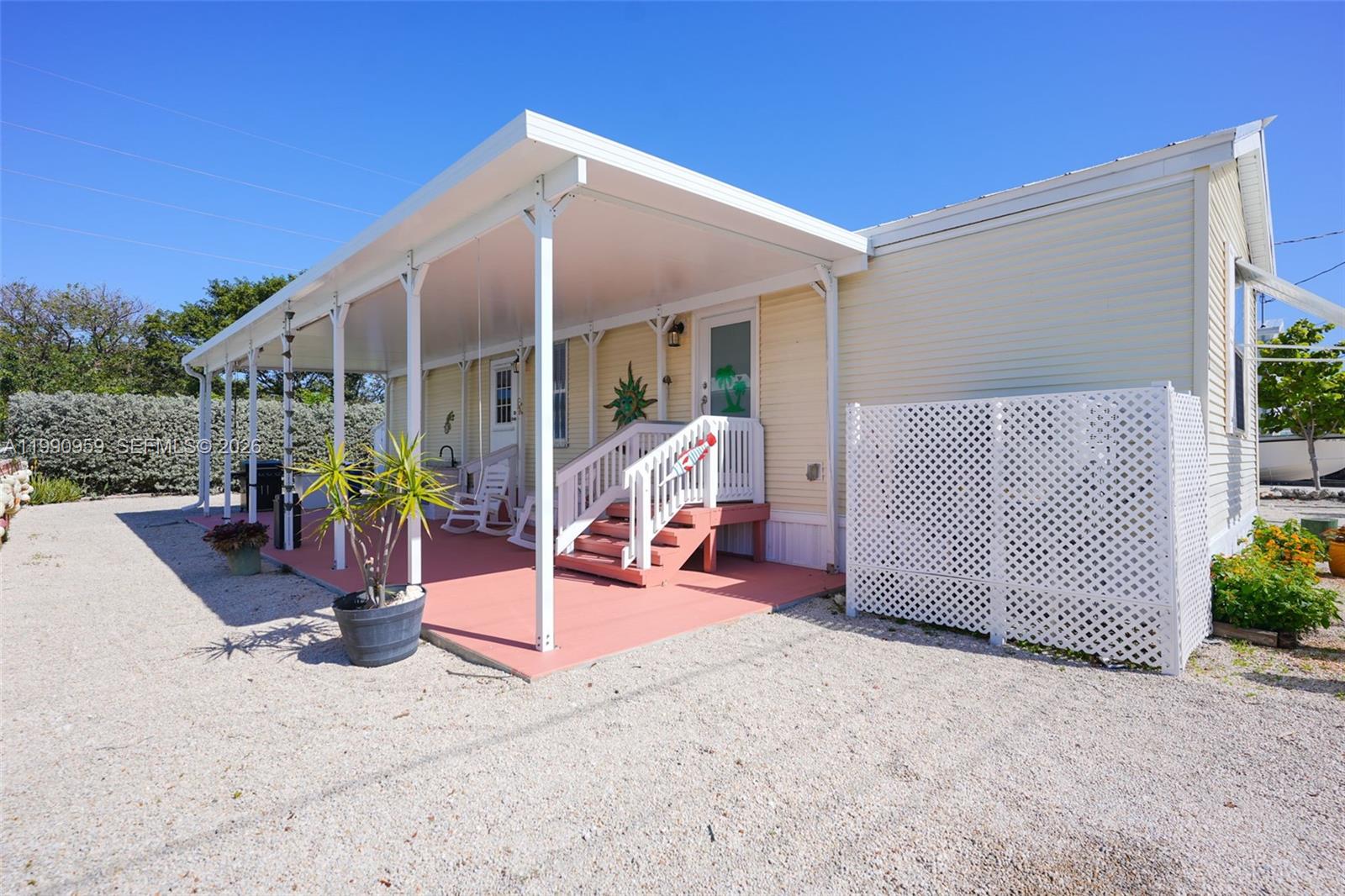 112 Tweedy Pie Terrace Key Largo, FL 33037 - Photo 4 of 39 a view of a patio with a table and chairs