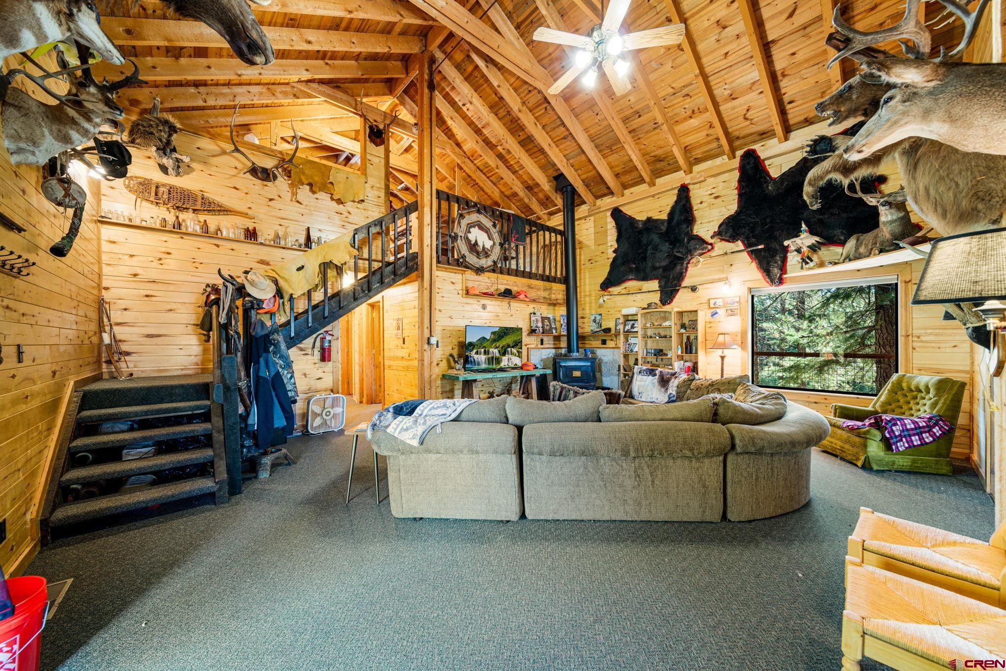 1875 Silver Mesa Driveway Durango, CO 81301 - Photo 12 of 27 a living room with furniture a flat screen tv and a floor to ceiling window