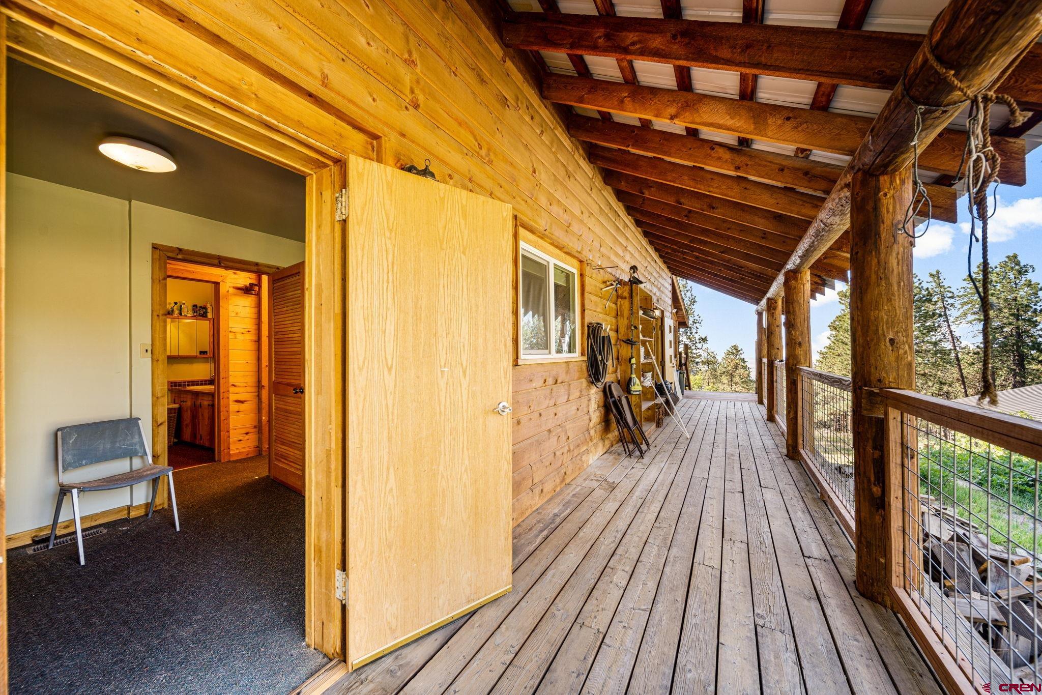 1875 Silver Mesa Driveway Durango, CO 81301 - Photo 14 of 27 a view of a hallway with wooden floor and furniture