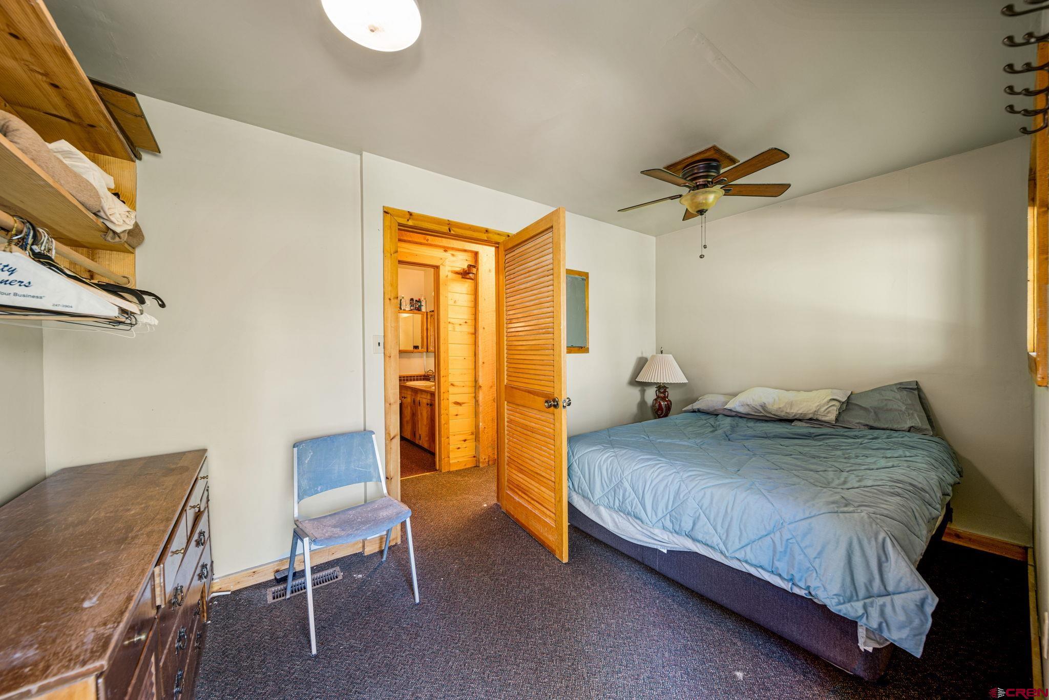 1875 Silver Mesa Driveway Durango, CO 81301 - Photo 20 of 27 a bedroom with a bed and chair