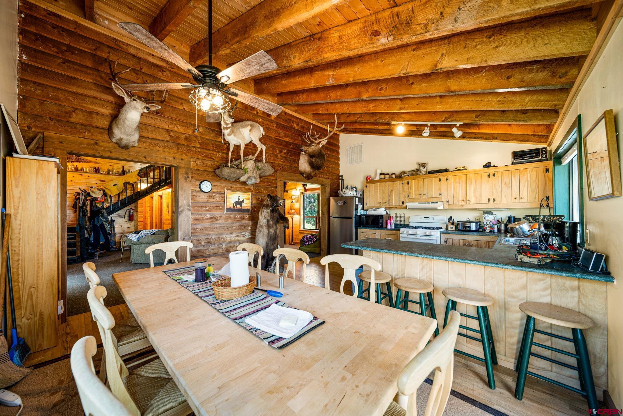 1875 Silver Mesa Driveway Durango, CO 81301 - Photo 10 of 27 a view of a dining room with furniture a chandelier and wooden floor