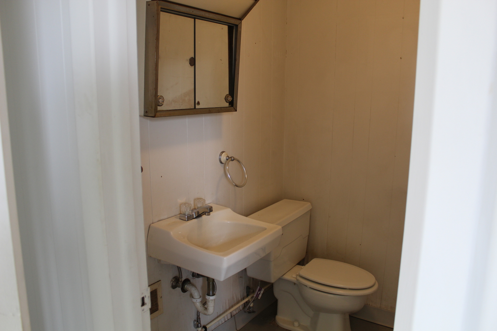804 East Walnut Street Watseka, IL 60970 - Photo 11 of 23 a bathroom with a toilet sink and mirror