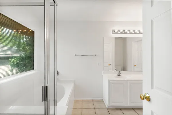a bathroom with a sink a mirror and a window