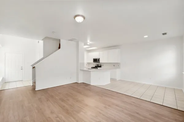 a view of a kitchen with wooden floor and a sink