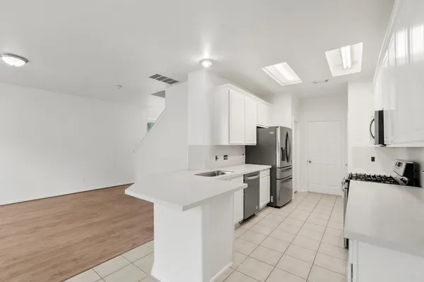 a kitchen with a sink cabinets and stainless steel appliances