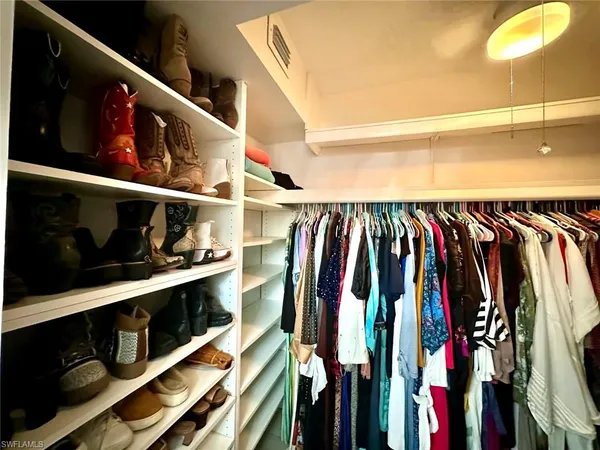a view of a livingroom with lounge chair and a large window