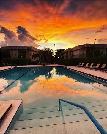 a kitchen with granite countertop a sink stainless steel appliances and white cabinets