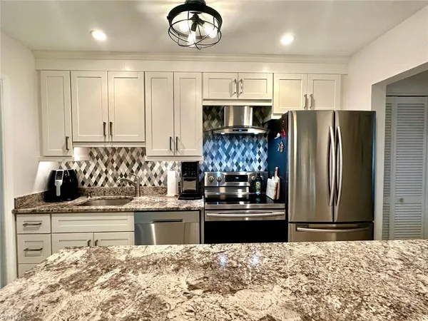 a view of a patio with table and chairs and potted plants
