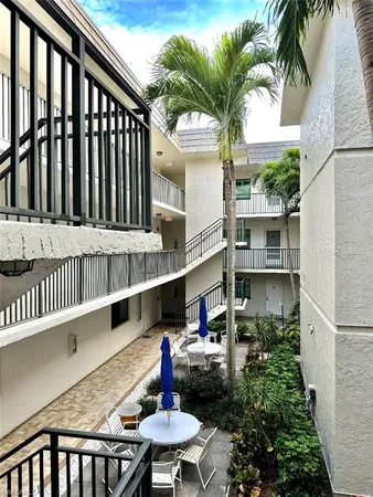 a view of backyard of house with outdoor seating