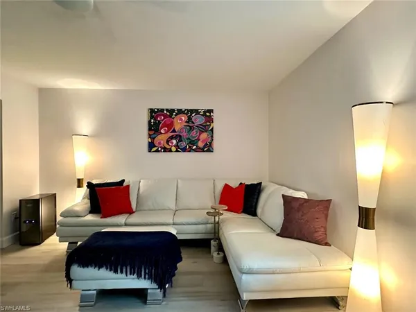 a large bed sitting in a bedroom next to a window