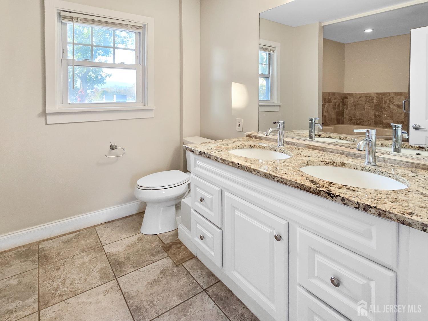 338 Runyon Avenue Middlesex, NJ 08846 - Photo 11 of 27 a bathroom with a granite countertop toilet sink and mirror