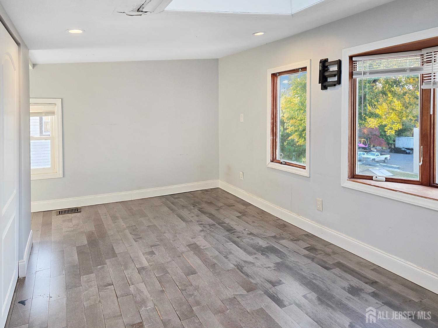 338 Runyon Avenue Middlesex, NJ 08846 - Photo 14 of 27 wooden floor in an empty room with a window