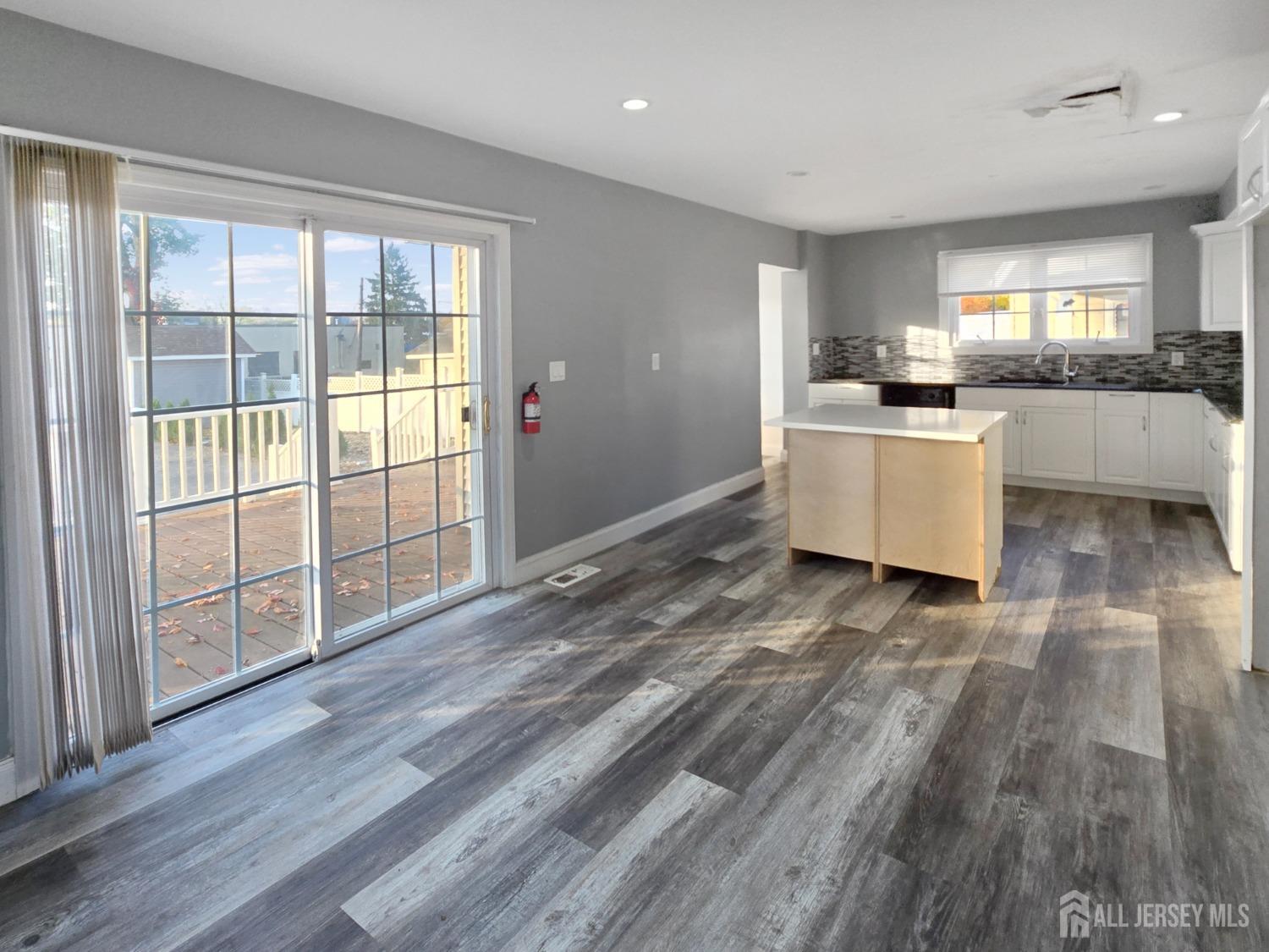 338 Runyon Avenue Middlesex, NJ 08846 - Photo 5 of 27 a view of a kitchen with furniture and wooden floor