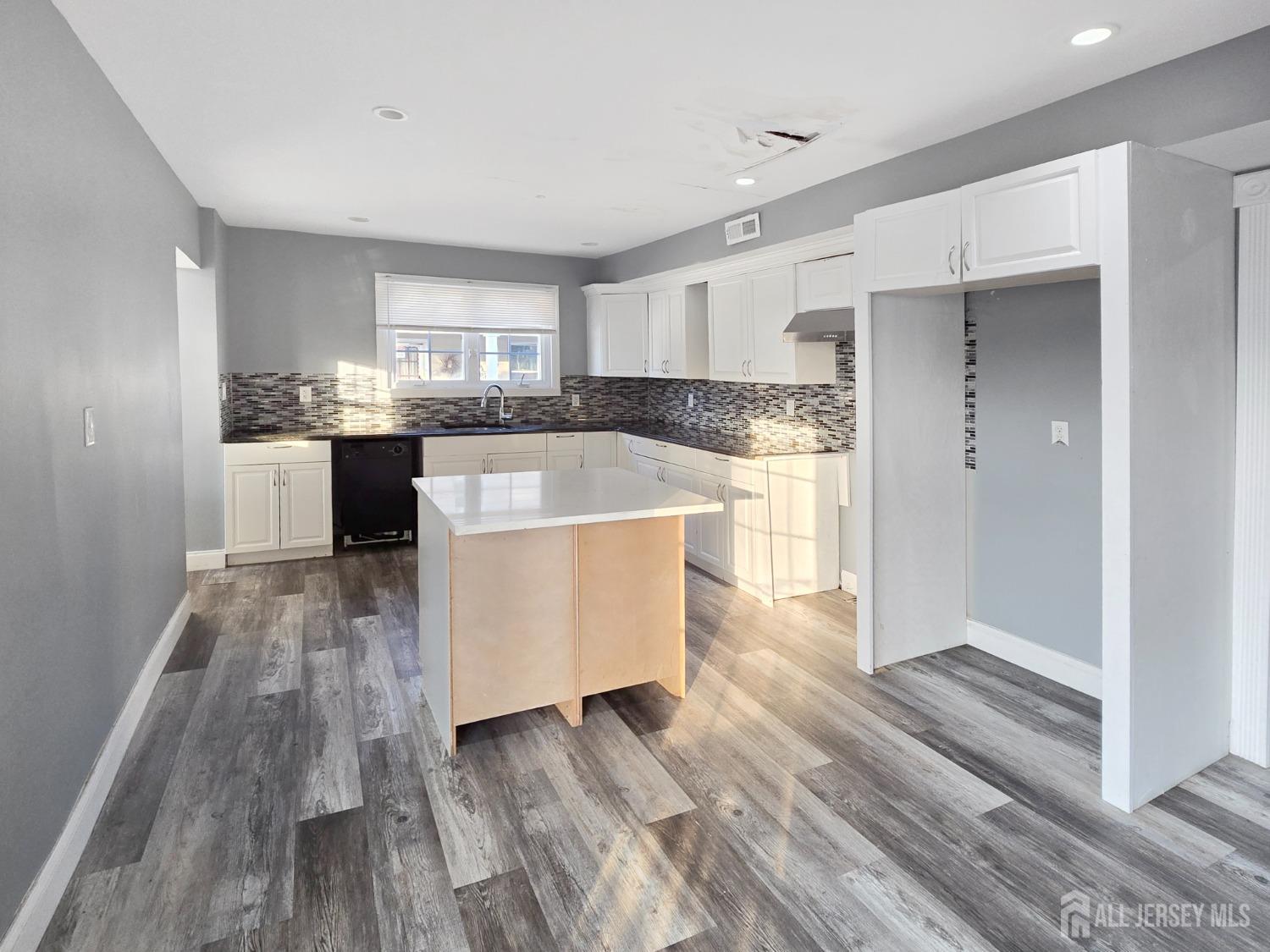 338 Runyon Avenue Middlesex, NJ 08846 - Photo 6 of 27 a kitchen with kitchen island wooden floors appliances and cabinets
