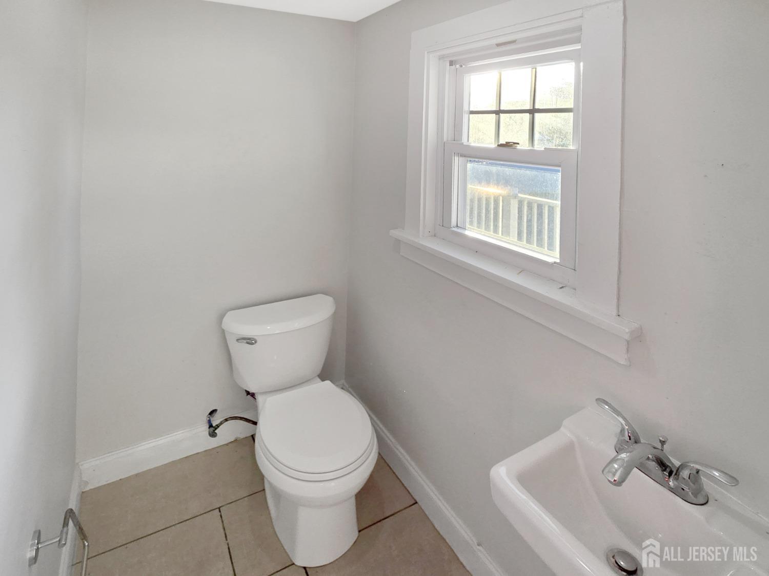 338 Runyon Avenue Middlesex, NJ 08846 - Photo 8 of 27 a bathroom with a toilet sink and mirror