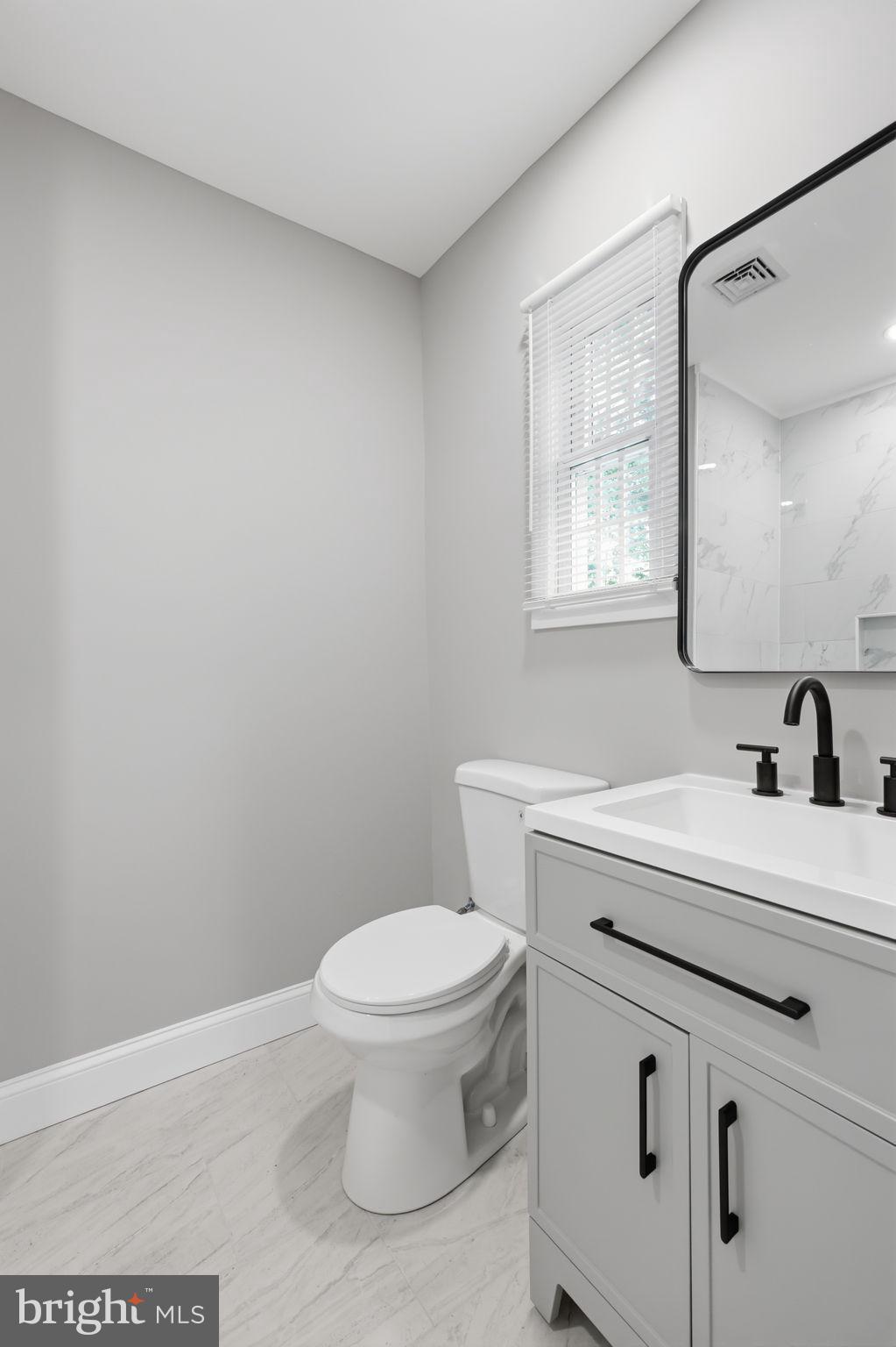 340 West Broad Street Hatfield, PA 19440 - Photo 21 of 55 a bathroom with a sink a toilet and a mirror