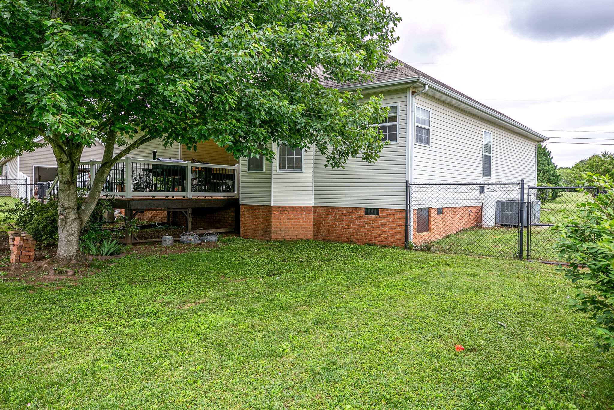 207 Towbridge Drive Murfreesboro, TN 37129 - Photo 31 of 31 a backyard of a house with wooden fence and large trees