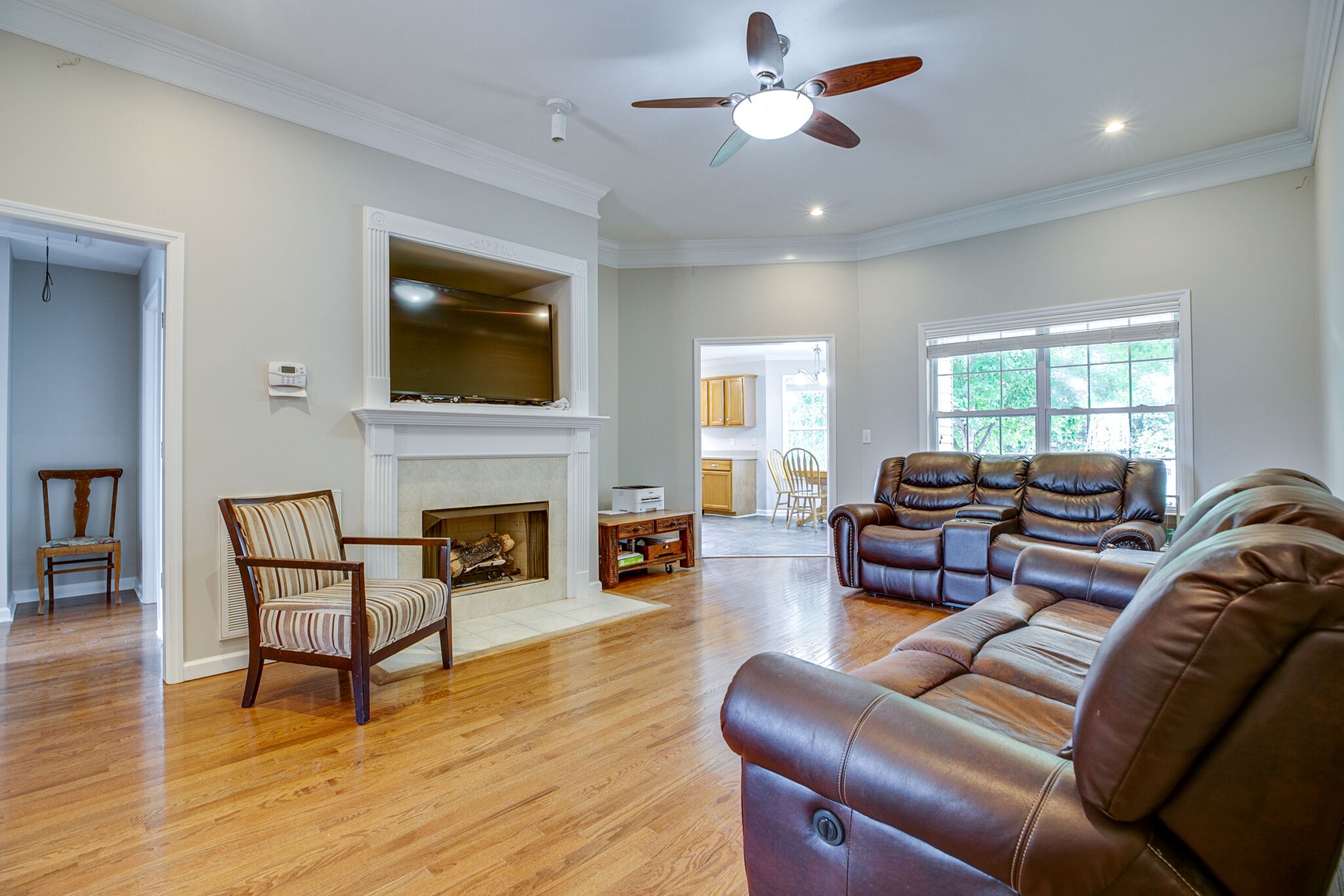 207 Towbridge Drive Murfreesboro, TN 37129 - Photo 8 of 31 a living room with furniture a fireplace and a flat screen tv