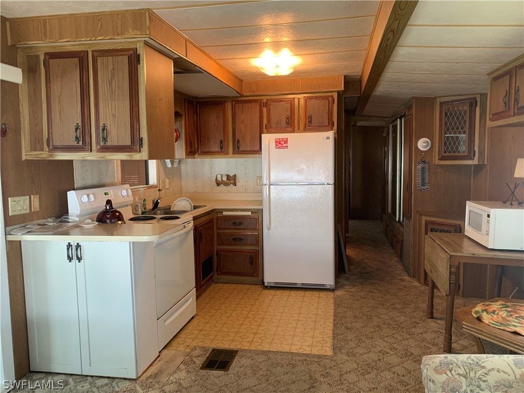 19681 Summerlin Road, Unit 195 Fort Myers, FL 33908 - Photo 3 of 12 a kitchen with refrigerator and cabinets